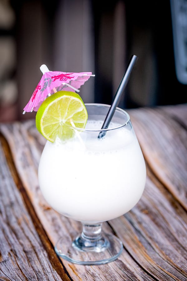 Coconut colada with lime and cocktail umbrella