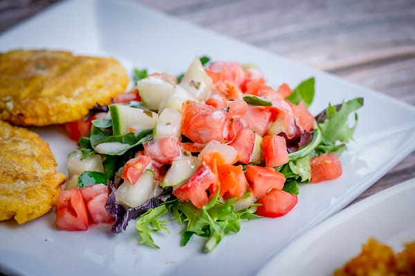Fresh tomato and cucumber salad with patacones