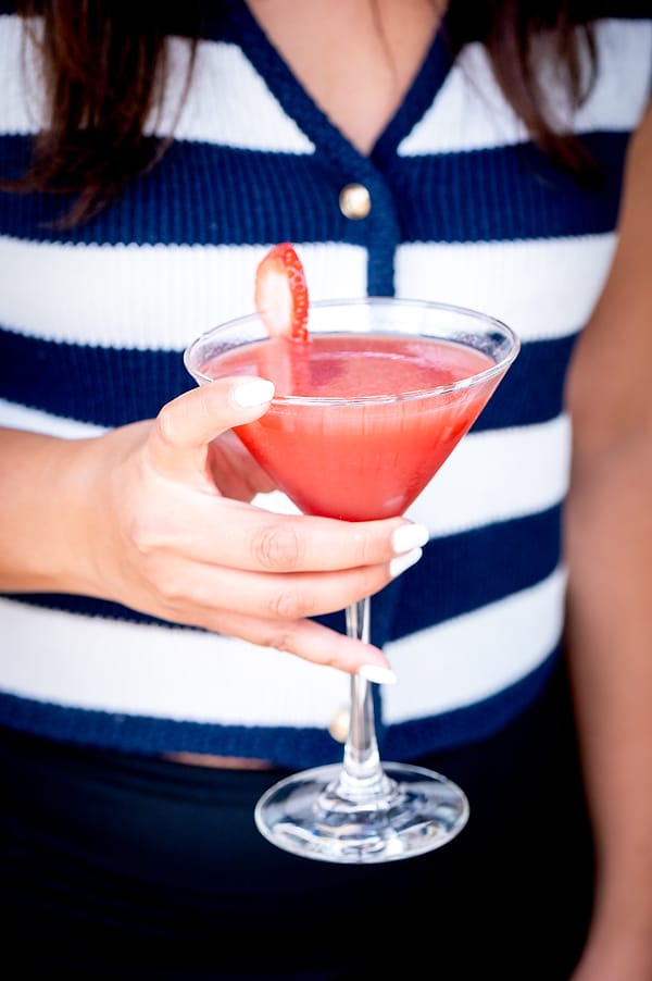 Strawberry martini held in hand